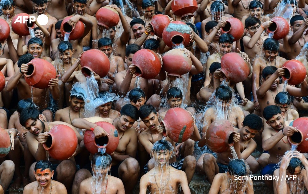 AFP picture by Sam Panthaky -  Holy bath in Ahmedabad, India - 2024