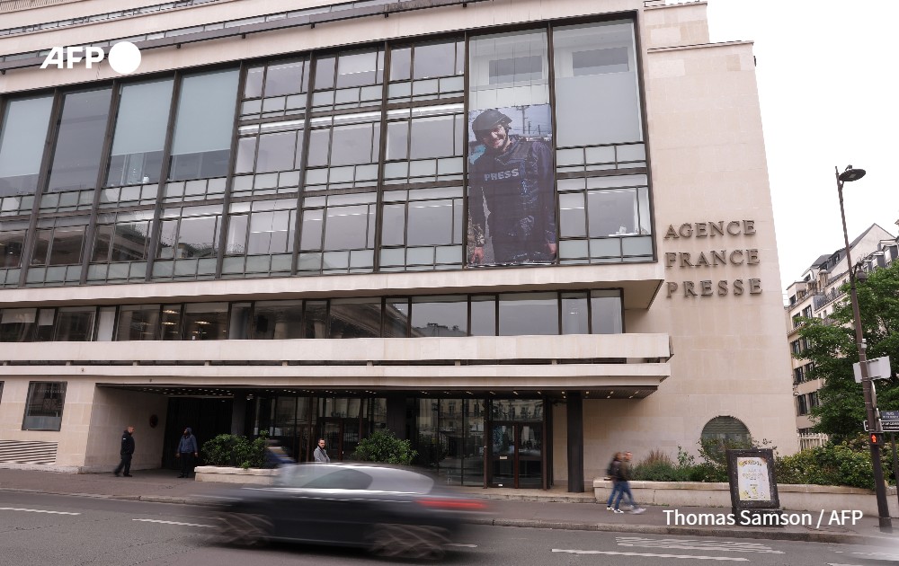 Photograph of AFP journalist Arman Soldin on the facade of agence France-Presse headquarters in Paris