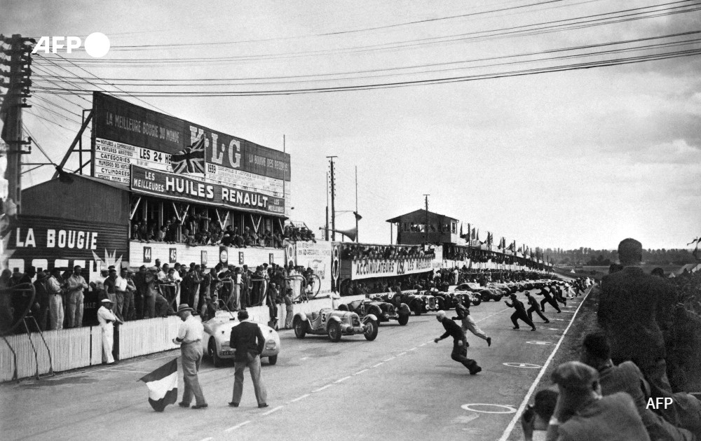 Race drivers run to their cars as they take the start of the race, in 1939