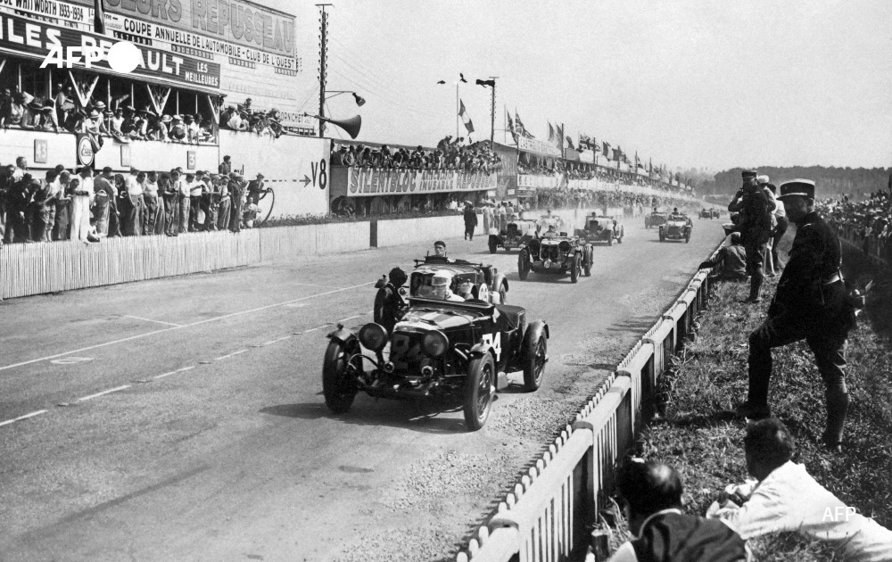 Race cars run on the pit straight, in 1934