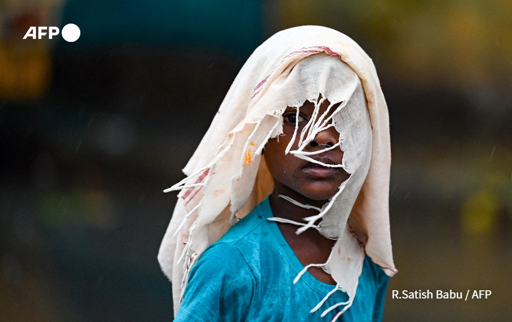 Boy covers himself with a cloth, India