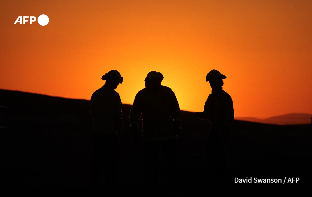 CalFire crewman walks through the charred grass