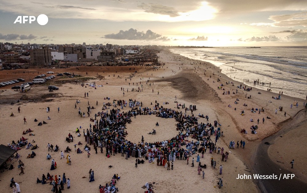 Muslim worshippers listening to the prayer performed at sea ceremony