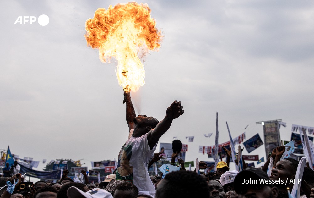 A man blows fire at a campaign rall