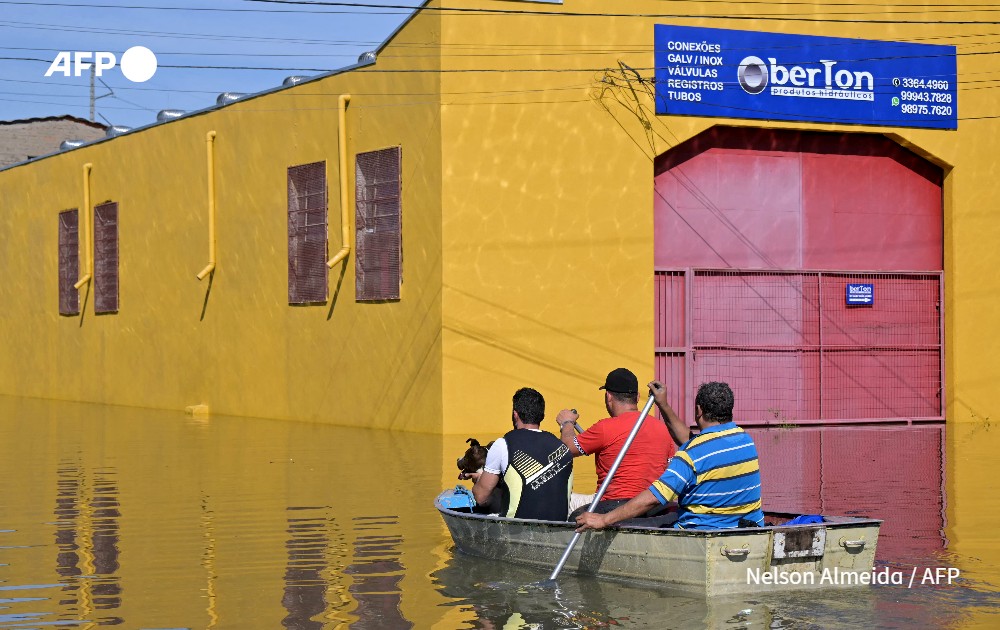 Locals move in boats following floodings due to heavy rains