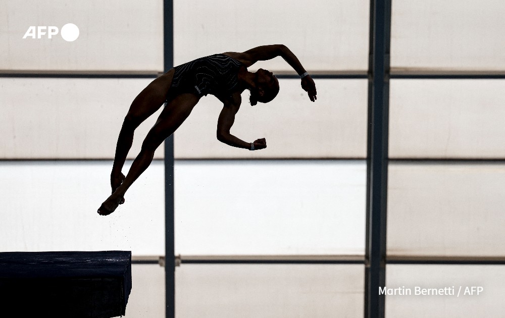 A diver trains in a swimming pool