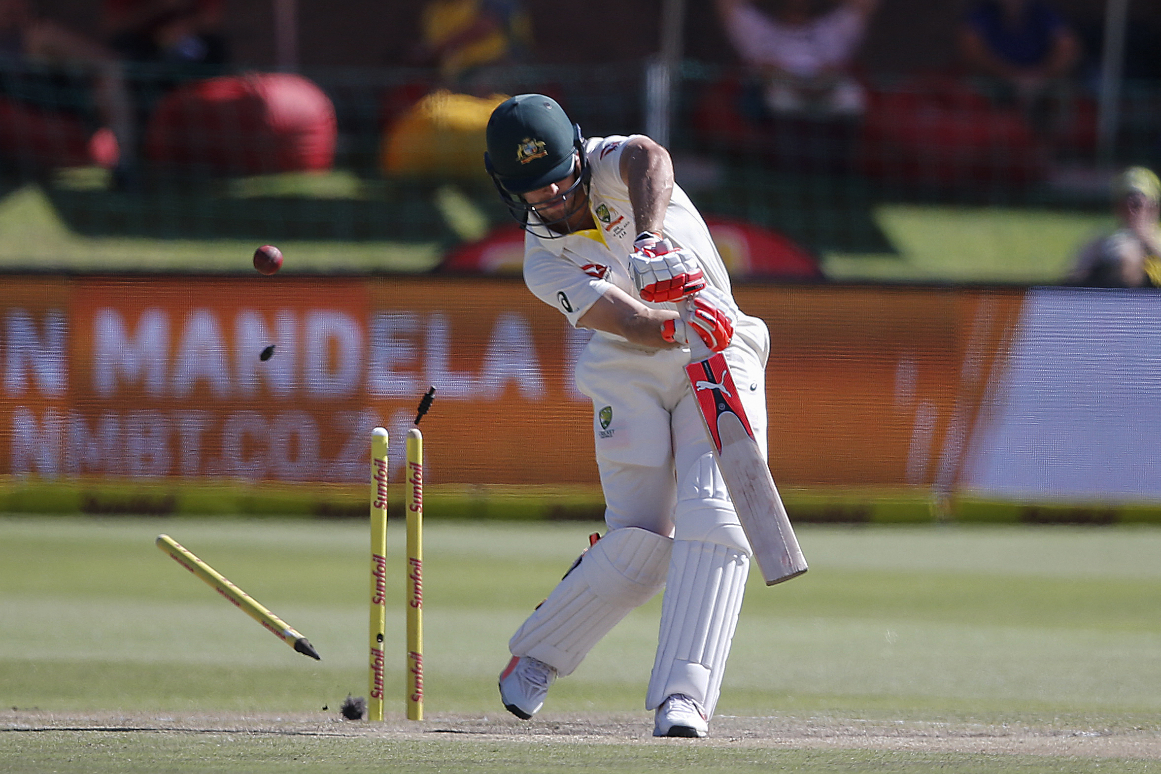 Bales are seen flying as the wicket of Australia batsman Mitchell Marsh is taken by South Africa bowler Kagiso Rabada  during day four of the second Cricket Test match between South Africa and Australia at St George’s Park in Port Elizabeth, on March 12, 2018. (Photo by MARCO LONGARI / AFP)