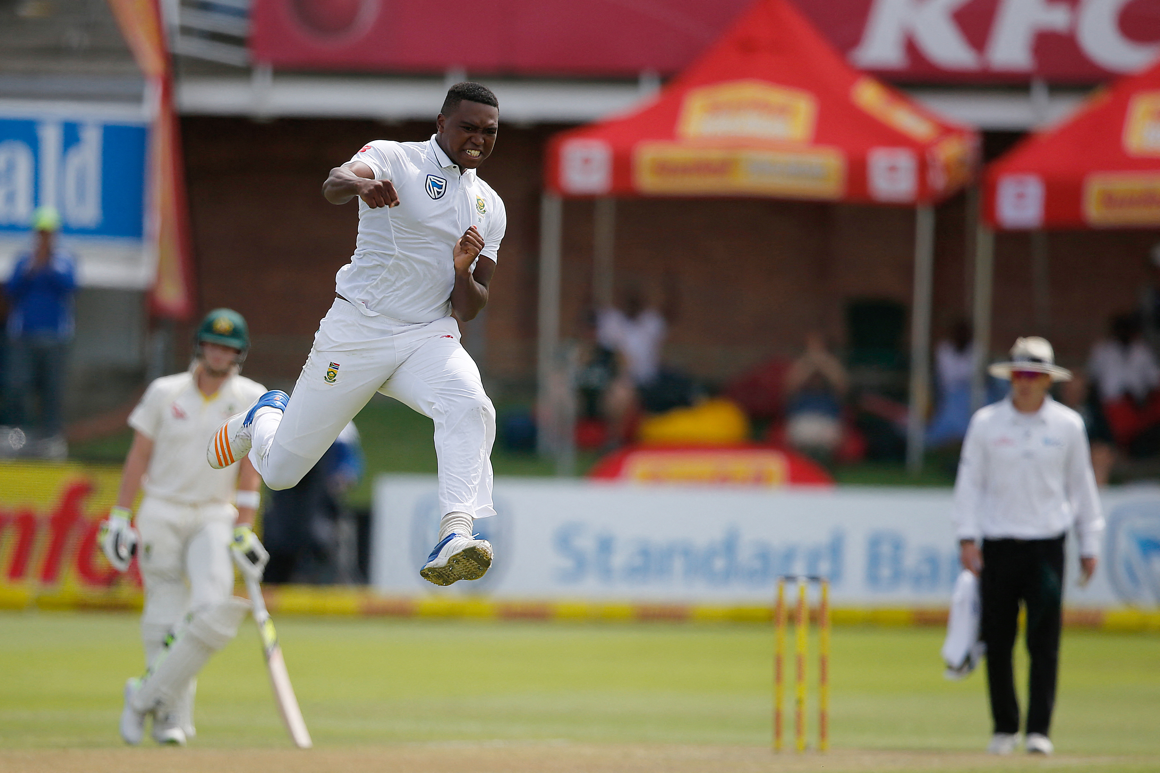 South Africa bowler Lungi Ngidi celebrates taking the wicket of Australia batsman David Warner during day one of the second Sunfoil Test between South Africa and Australia at St George's Park in Port Elizabeth, on March 9, 2018. (Photo by MARCO LONGARI / AFP)