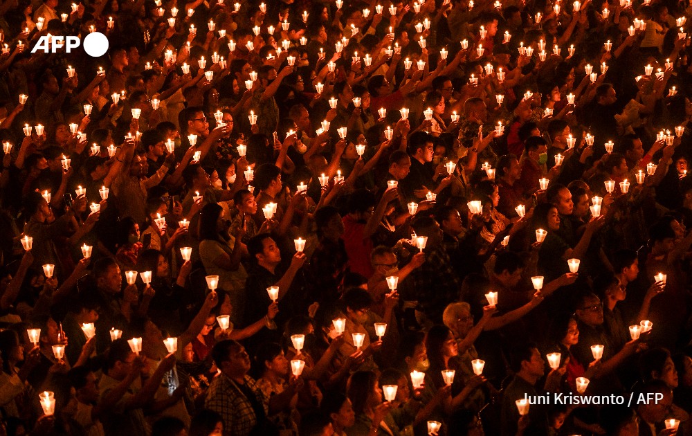 Christian devotees hold candles