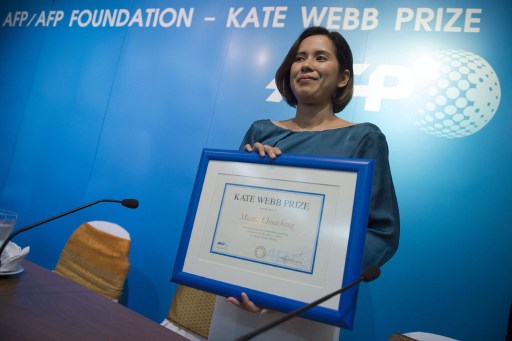 THAILAND, Bangkok : This photo taken on December 1, 2015 shows Thai reporter Mutita Chuachang, 33, who works for Thai news site Prachatai, posing with her Agence France Presse (AFP) Kate Webb Prize at the FCCT (Foreign Correspondant Club Thailand) 