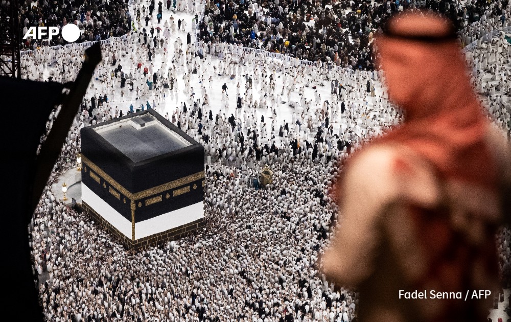 Muslim worshippers walk around the Kaaba