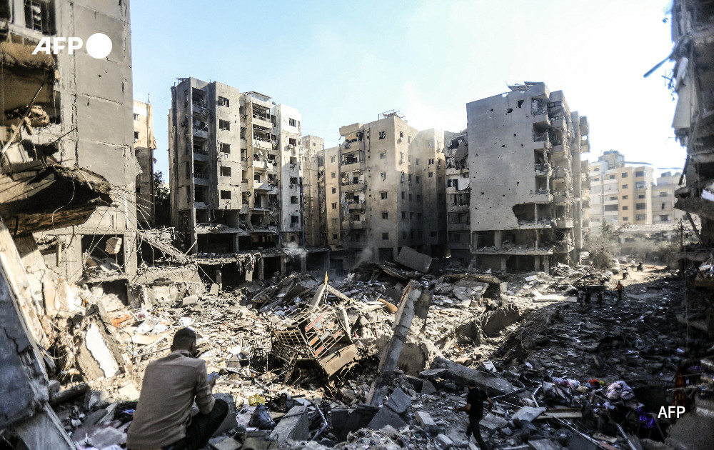 People check the rubble of buildings which were levelled on September 27 by Israeli strikes that targeted and killed Hezbollah leader Hassan Nasrallah in the Haret Hreik neighbourhood of Beirut's southern suburbs.