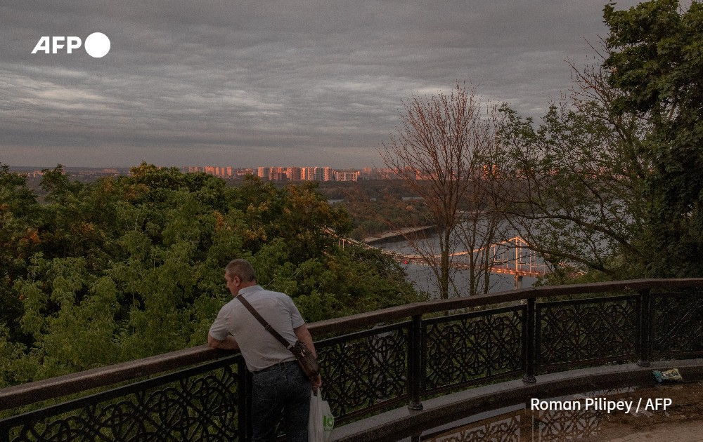 A man stands at a city's observation deck